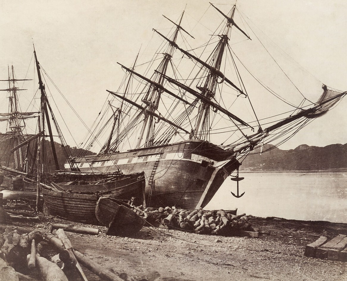 photo, slanted boat on shore, sepia toned